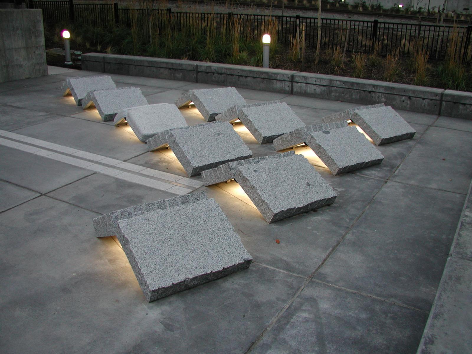 Abstract concrete blocks forming part of Terminus, along the Prairie Line Trail and lit from below. Photo credit UW Tacoma