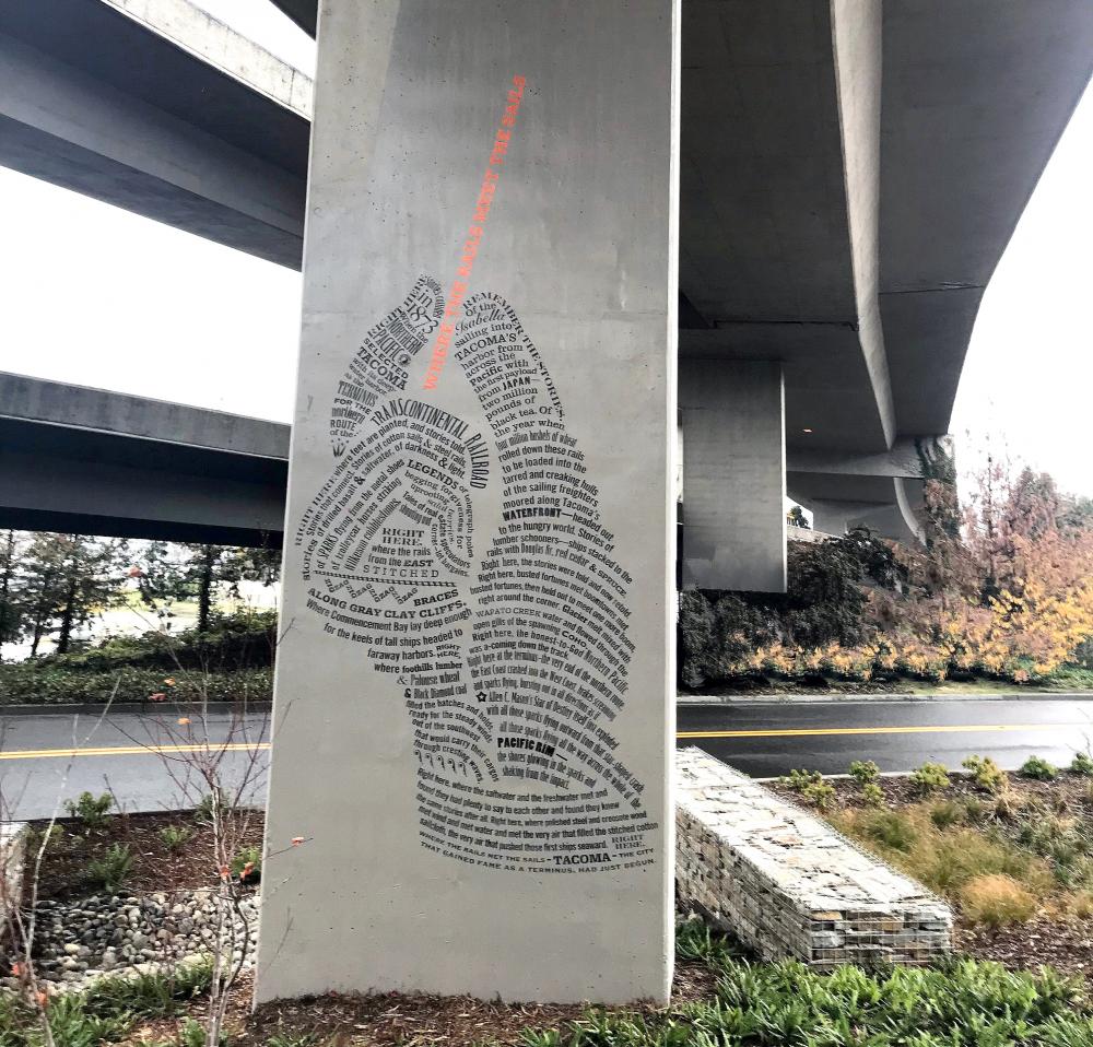 The mural component, a hand holding a needle.